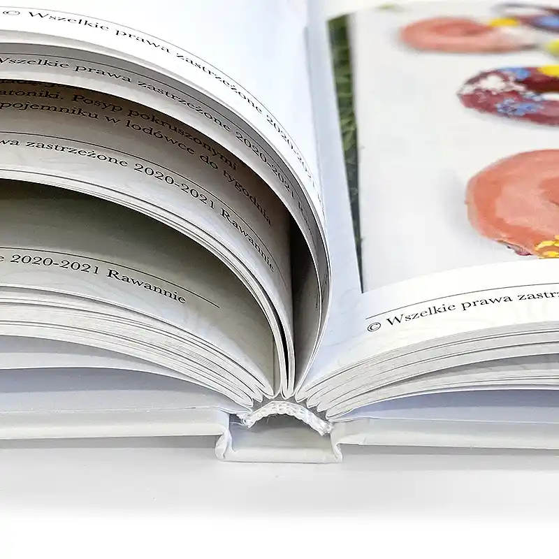 A cookbook in a hard-stitched and glued cover. Matte coated paper 135g. White headband