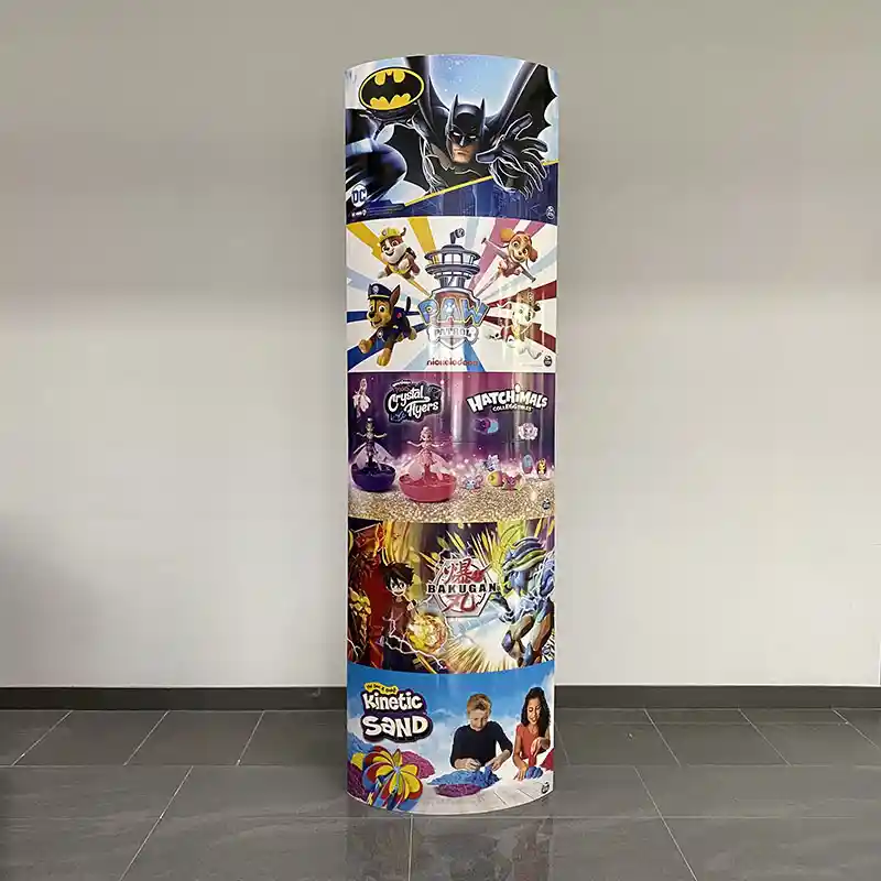 An elliptical 1800x600 mm cardboard totem with a glossy laminate on the surface.